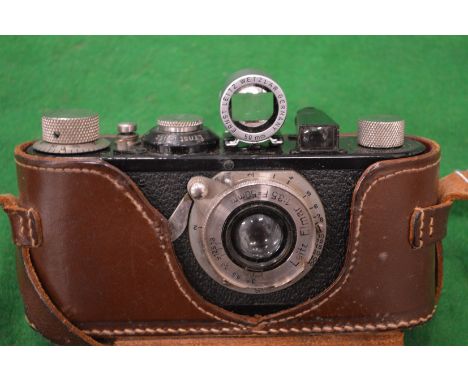A Leitz Elmar 50mm camera with leather case.