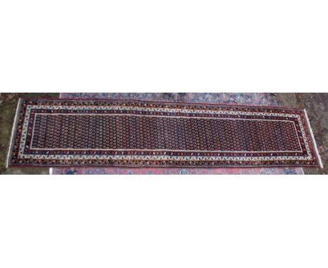 A good Persian runner or hall carpet, rich blue ground with stylised Boteh decoration 14'9" x 3'6".