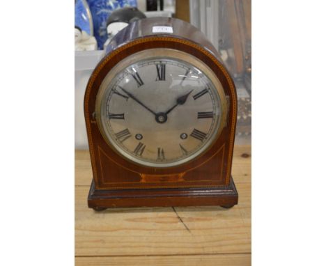 A mahogany mantle clock.