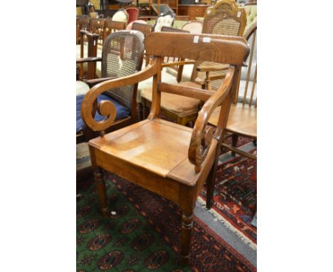 An oak commode chair.