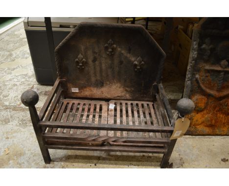 Cast iron fire grate with integral cast iron back.