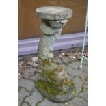 A pair of composite garden stands modelled as classical dolphins.