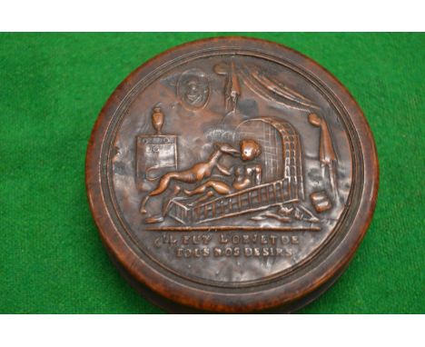 An embossed wood and tortoiseshell circular snuff box and cover.