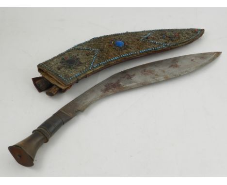 An East Asian khukuri, the scabbard embellished with red, green and turquoise gems. 