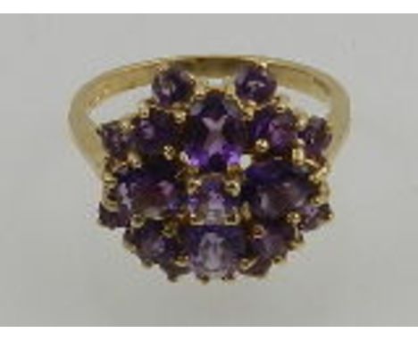 A 9 carat yellow gold and amethyst cluster ring. 