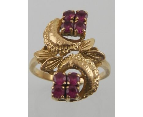 A yellow metal and ruby ring, of naturalistic design, set eight round cut rubies. 