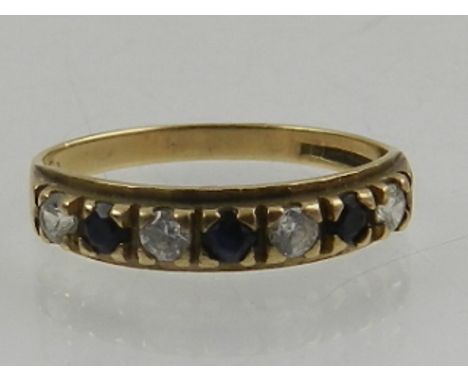 A 9 carat yellow gold, blue and white sapphire seven stone ring. 