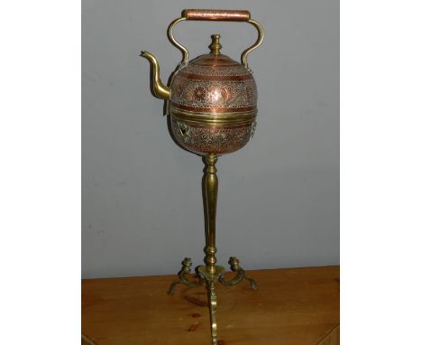 A North African brass tea pot, on tripod stand. H: 82cm