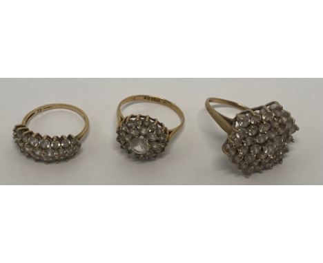 Three 9ct gold ladies dress rings, each set with clusters of white stones, sizes K-L, 12g.