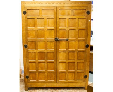 Robert (Mouseman) Thompson of Kilburn, an oak double wardrobe, circa 1925, trellis panelled throughout with a dentil moulded 