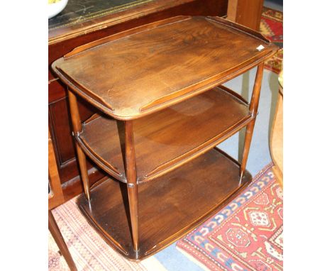 An Ercol Windsor dark elm and beech three tier trolley, on wheels, 72cm wide, 74cm high, 47cm deep