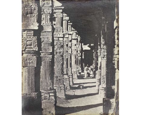 DELHI AND LUCKNOWA view of the colonnade of the Qutub Minar, Delhi with man seated,  albumen print, by an unidentified photog