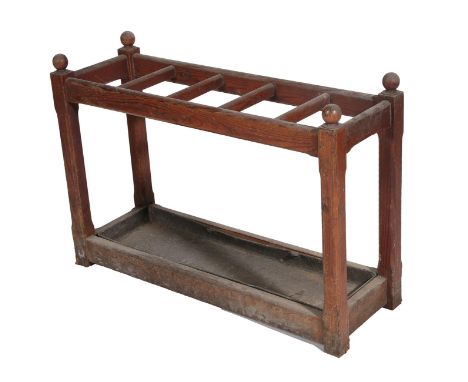 ~ A Victorian Pitch Pine Five Division Stick Stand, late 19th century, with turned finials, chamfered supports enclosing a re