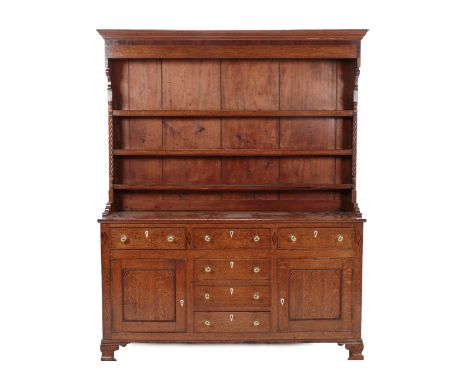 A Late George III Oak and Pine-Lined Dresser and Rack, the moulded cornice above a crossbanded frieze and three fixed shelves