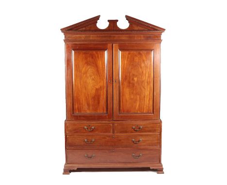 ~ A George III Mahogany Linen Press, late 18th century, the architectural and dentil cornice above two moulded cupboard doors