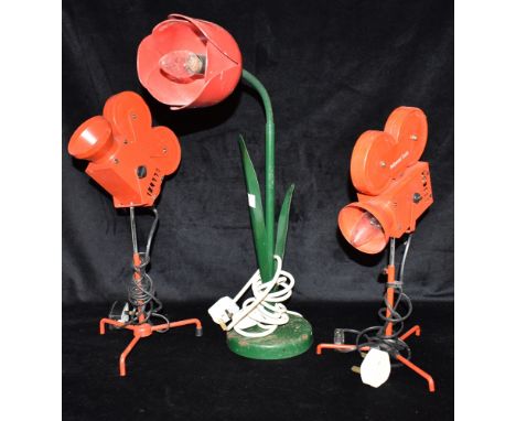 A METAL ADJUSTABLE DESK LAMP  in the form of a flower, together with a pair of table lamps in the style of movie cameras Cond