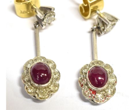 A PAIR OF 18CT WHITE GOLD RUBY AND DIAMOND PENDENT FLOWER HEAD EARRINGS earring length excluding bale 1.8cm, the oval ruby ca