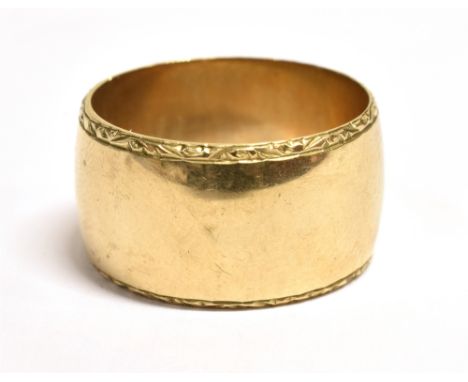 A VINTAGE 9CT WIDE BAND RING The ring with patterned boarders hallmarked for London 1968, maker BWRS, ring size R, ring width