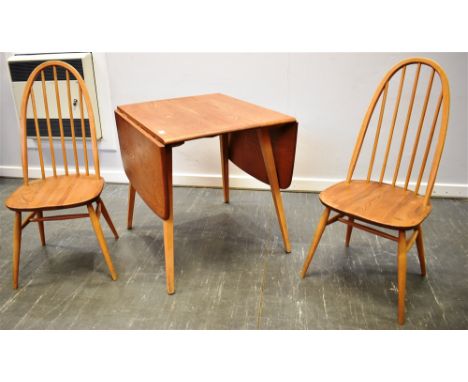 AN ERCOL LIGHT ELM AND BEECH DROP-LEAF KITCHEN TABLE  74cm deep 136cm wide with both leaves extended, together with a pair of