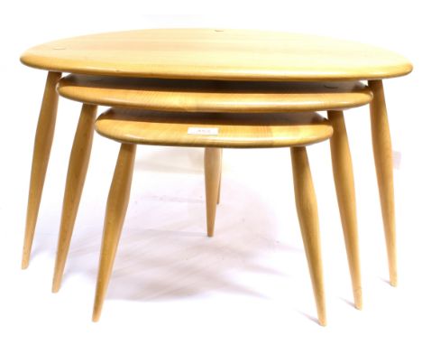 AN ERCOL NEST OF THREE BLONDE ELM AND BEECH 'PEBBLE' OCCASIONAL COFFEE TABLES, MODEL 354  the largest 40cm x 65cm Condition R