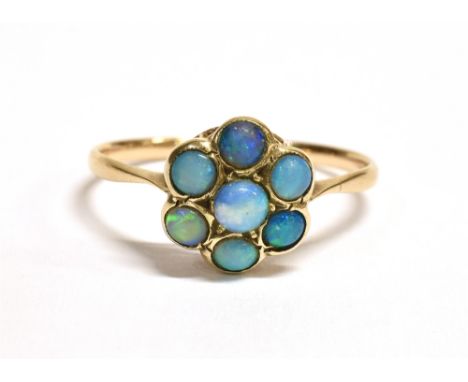 A 9CT GOLD, OPAL FLOWER HEAD RING faded markings to shank, flower head size approx. 9mm in diameter, ring size P