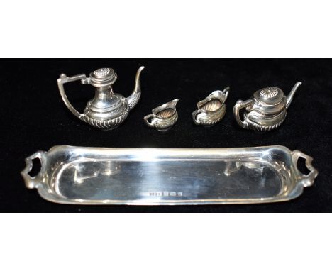 A MINIATURE SILVER TRAY with a four piece miniature silver tea service, all hallmarked for Birmingham 1973, maker JR, the two