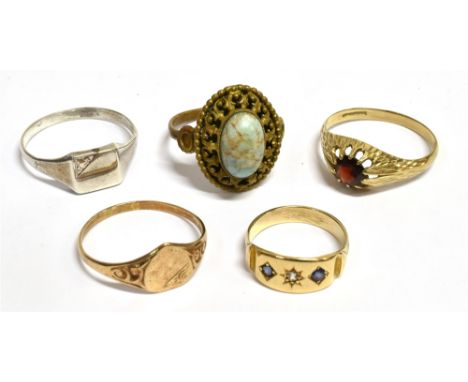 A COLLECTION OF FIVE RINGS  comprising an unmarked small yellow metal gypsy set ring, ring size K, weight 2.5grams, testing i