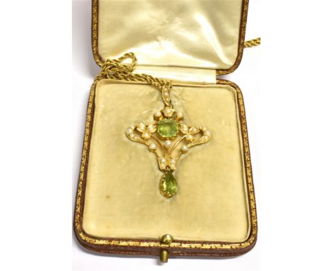 AN ART NOUVEAU PERIDOT AND SEED PEARL PENDANT PIECE Suspended from a 9ct gold rope twist chain, the pendant measuring 4.7 cm 