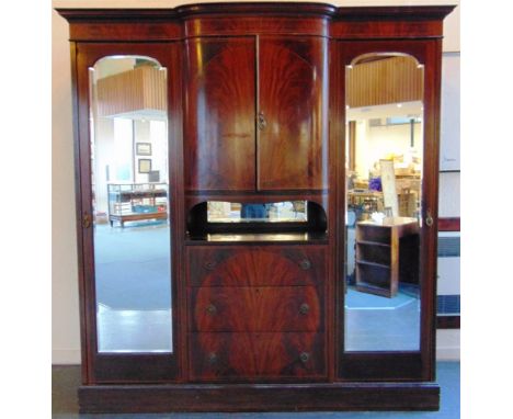 AN EDWARDIAN INLAID MAHOGANY TRIPLE WARDROBE,  the central section with bow front cupboard over three drawers, flanked by mir