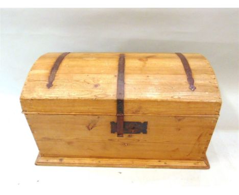 A LARGE IRON BOUND WAXED PINE TRUNK  with domed top, 104cm wide 55cm deep 57cm high