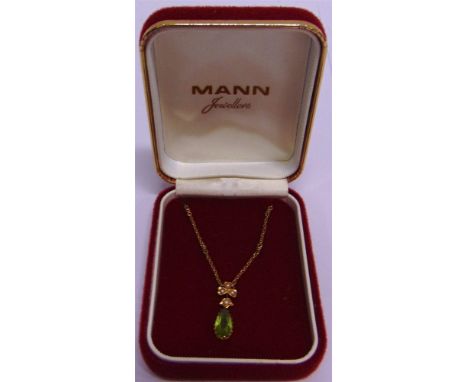 A PERIDOT AND SEED PEARL PENDANT  the tear shaped stone leaf motifs above, 2.4cm long, on a chain; later case 