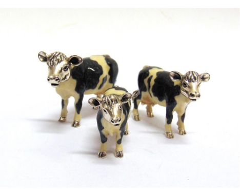 SATURNO, ITALY: A GRADUATED SET OF THREE SILVER AND ENAMEL COWS,  the largest approx 75mm nose to tail