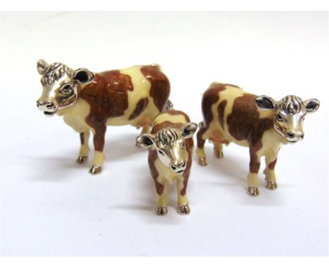 SATURNO, ITALY: A GRADUATED SET OF THREE SILVER AND ENAMEL COWS,  the largest approx 75mm nose to tail 