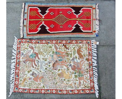A SMALL FLAT WOVEN RUG 47CM X 91CM;  and an embroidery depicting a hunting scene 63cm x 89cm (2)