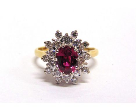 A RUBY & DIAMOND CLUSTER 18 CARAT GOLD RING the oval cut of approximately 1.3 carats enclosed by twenty brilliant cuts totall
