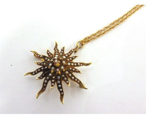 A SEED PEARL SET SUN IN SPLENDER PENDANT BROOCH stamped '14K', 4cm across, on a rope chain, 55cm long, 10.7g gross