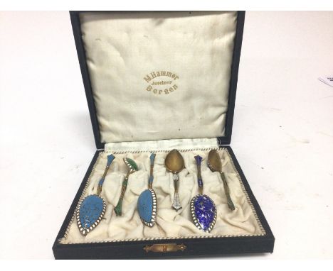 A cased set of six coloured enamel and silver Norwegian teaspoons spoons
