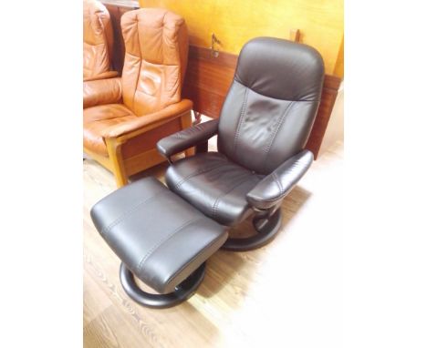 An Ekornes Stressless black leather reclining and swivel lounge chair with matching stool.Condition- good, only very light si