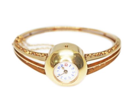 A late Victorian/Edwardian ladies bangle watch, white enamel dial with outer gold dot minutes, blue and red Arabic numerals, 