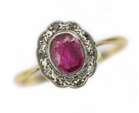 An antique ruby and diamond ring, the oval cluster measuring approx. 10mm x 9mm, band marked 'PT 18ct', gross wt. 2.4g, size 