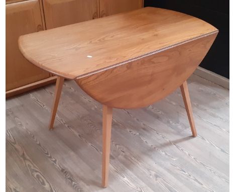 An Ercol light elm drop leaf table, model 384, designed in 1956 by Lucian Ercolani, height 72cm, width 114cm and depth 63cm.