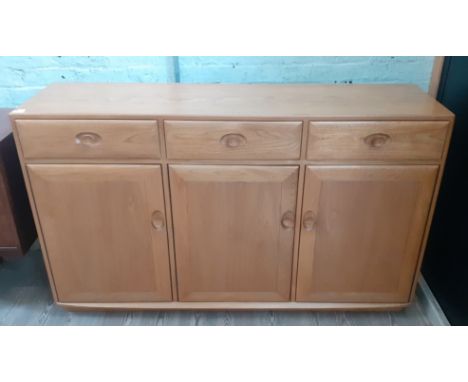 An Ercol 'Windsor' light elm high sideboard, length 155.5cm, height 93cm and depth 45cm. Condition- good, very slight knock t