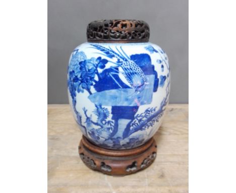 A Chinese Kangxi period blue and white ginger jar, decorated with exotic birds and trees, double ring mark to base, later car
