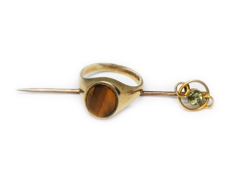 A hallmarked 9ct gold tiger's eye signet ring and a peridot set stick pin marked '9ct', gross wt. 3.6g.  