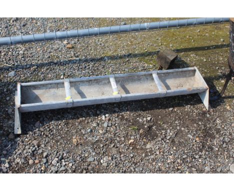 A galvanised four partitioned feed trough