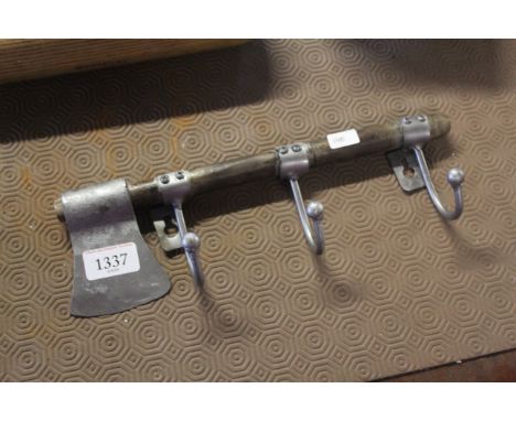 A wall mounting three hook coat rack mounted to a hand axe (140)