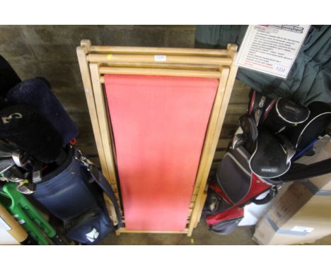 A pair of light wood folding deck chairs