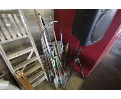 A metal set of folding steps and a quantity of long handled gardening tools including digging fork, rakes, branch loppers etc