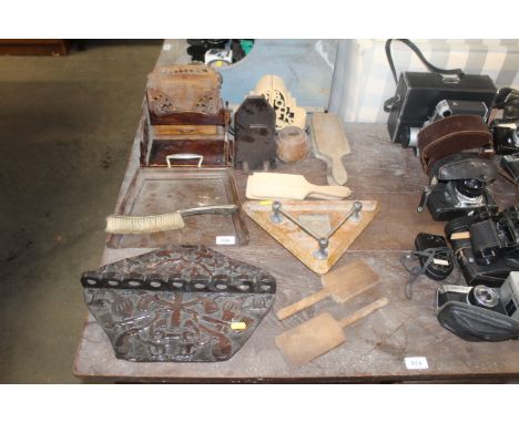 A collection of wooden items to include crumb tray and brush, book ends, butter pats, pipe rack etc.