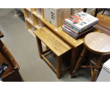 A graduated pair of light oak occasional tables